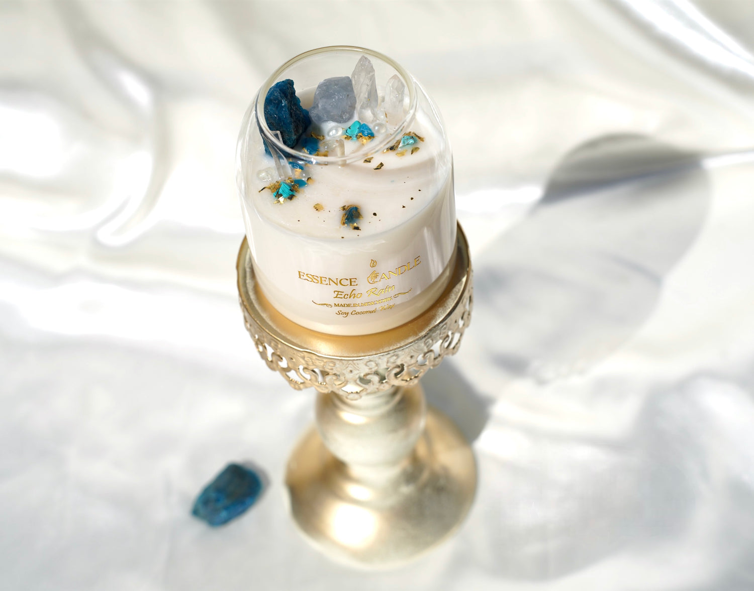 Eco-friendly Echo Rain crystal candle, 17 oz jar with rainforest aroma, obsidian, amazonite, and clear quartz. Soy coconut wax blend with gold accents, artisan crafted in New York.